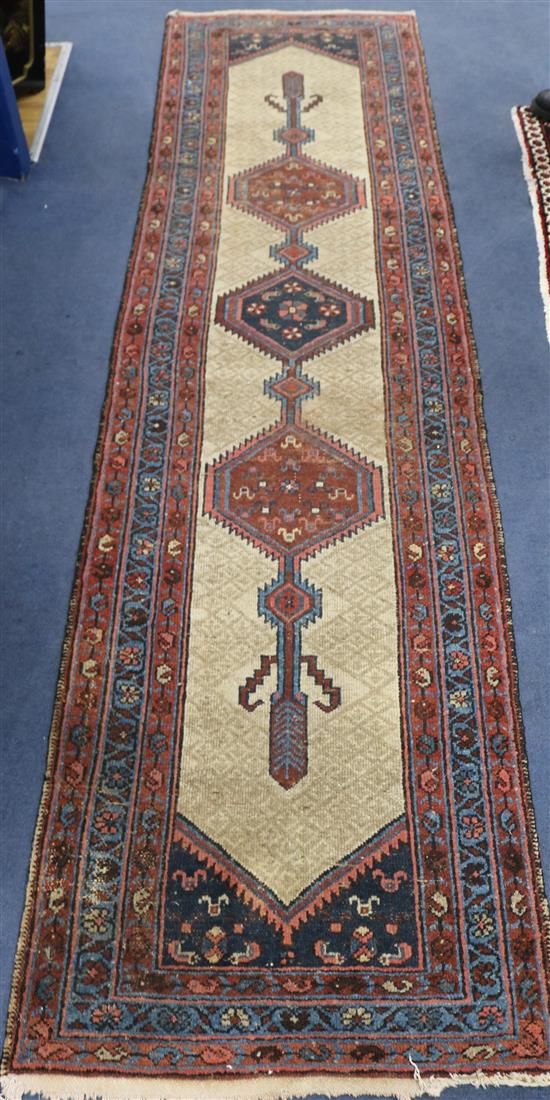 A Persian ivory and red ground runner, 9ft 8in by 2ft 6in.